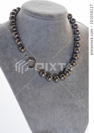 author beautiful steel color pearls necklaces with heart pendant demonstrated on maneken. fashion and jewelry concept author beautiful steel color pearls necklaces with heart pendant demonstrated on maneken. fashion and jewelry concept 101058117