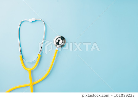 Yellow medical stethoscope isolated on blue background with copy space for you text, Doctor equipment, Overcoming the disease, Doctor Day Concept 101059222