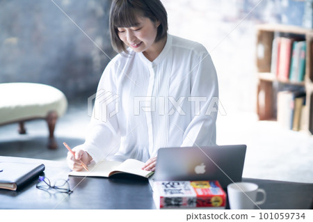 Young woman studying for a qualification exam 101059734