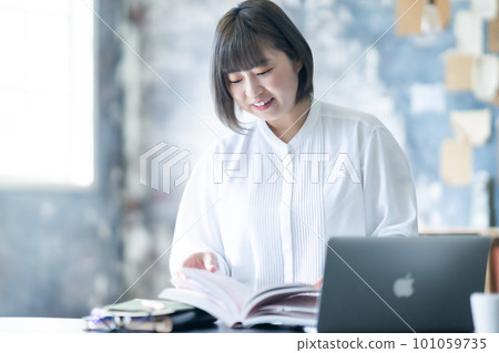 Young woman studying for a qualification exam 101059735