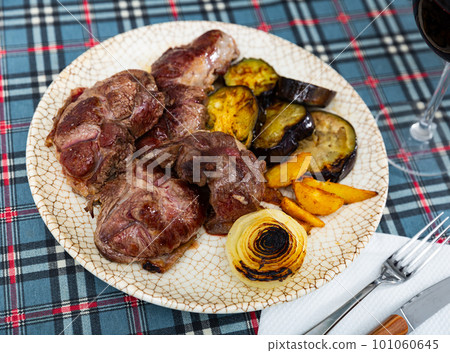Tasty sliced grilled beef served with potatoes and eggplant Tasty sliced grilled beef served with potatoes and eggplant 101060645