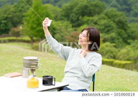 A woman taking a selfie at a solo camp 101060819