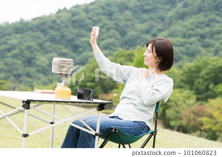A woman taking a selfie at a solo camp 101060823