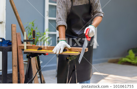 Woodworking is a hobby for male senior after retirement at home. Woodworking is a hobby for male senior after retirement at home. 101061755