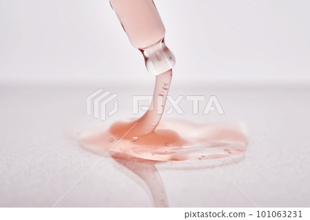 Pipette with a viscous pink cosmetic close-up. Pipette with a viscous pink cosmetic close-up. 101063231