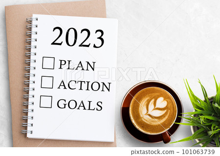 2023 PLAN ACTION GOALS Text on Blank notebook on white office desk background. 101063739
