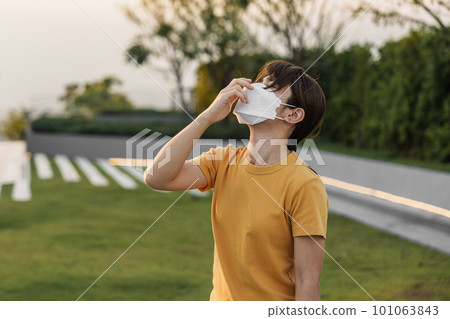young Asian woman wearing N95 respiratory mask protect and filter pm2.5 or particulate matter against bad Air Pollution in City. Air Quality Index, AQI, Unhealthy, healthcare concept young Asian woman wearing N95 respiratory mask protect and filter pm2.5 or particulate matter against bad Air Pollution in City. Air Quality Index, AQI, Unhealthy, healthcare concept 101063843