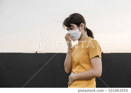 young Asian woman wearing N95 respiratory mask protect and filter pm2.5 or particulate matter against bad Air Pollution in City. Air Quality Index, AQI, Unhealthy, healthcare concept 101063850