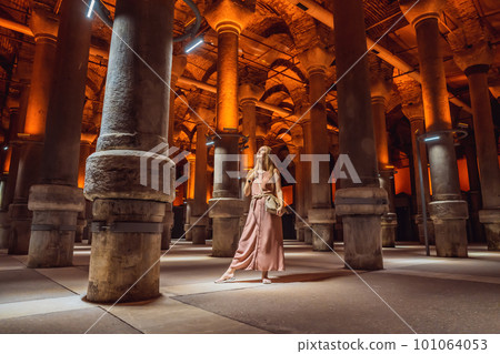 Woman tourist enjoying Beautiful cistern in Istanbul. Cistern - underground water reservoir build in 6th century, Istanbul, Turkey, Turkiye Woman tourist enjoying Beautiful cistern in Istanbul. Cistern - underground water reservoir build in 6th century, Istanbul, Turkey, Turkiye 101064053