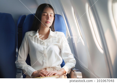 Beautiful Asian business woman sleeping in luxury flight. working, travel, business concept 101067048