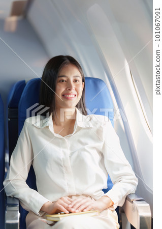 Beautiful Asian business woman happy and smile in luxury flight. working, travel, business concept Beautiful Asian business woman happy and smile in luxury flight. working, travel, business concept 101067091