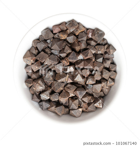 Magnetite crystals in a white bowl. Iron(II,III) oxide, octahedral, double pyramid and Platonic solid shaped. Most magnetic of all naturally occurring minerals. Can also be found in the human brain. Magnetite crystals in a white bowl. Iron(II,III) oxide, octahedral, double pyramid and Platonic solid shaped. Most magnetic of all naturally occurring minerals. Can also be found in the human brain. 101067140