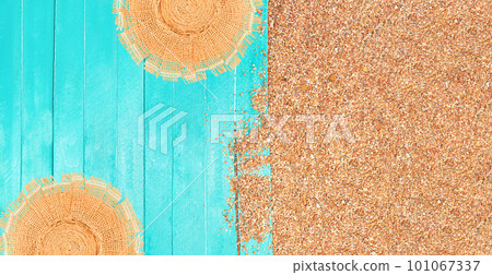 Summer comosition. Beach layout. Pebbled sand with azure wooden pier or sun lounger with straw hat. Travel and tourism. Copy space 101067337