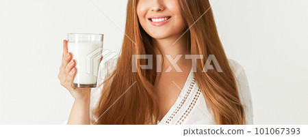 Diet, health and wellness concept, woman holding glass of milk or protein shake cocktail 101067393