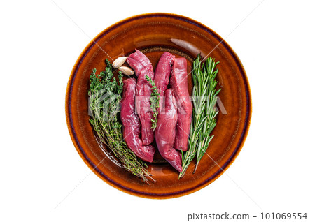 Uncooked Raw lamb tenderloin Fillet Meat in rustic plate with thyme and rosemary. Isolated background Uncooked Raw lamb tenderloin Fillet Meat in rustic plate with thyme and rosemary. Isolated background 101069554