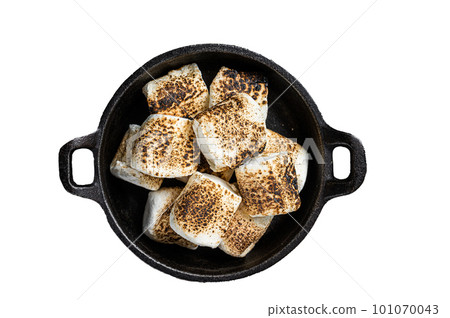 Toasted Marshmallow on open campfire in a skillet. Isolated on white background. Toasted Marshmallow on open campfire in a skillet. Isolated on white background. 101070043
