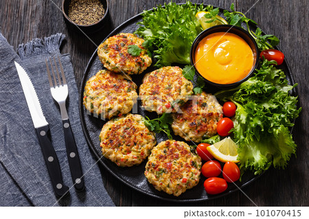crab cakes with sauce, lettuce, tomatoes, lemon crab cakes with sauce, lettuce, tomatoes, lemon 101070415