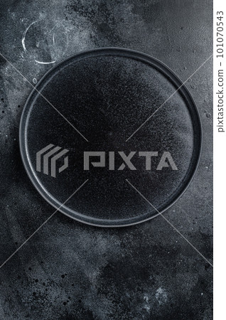 Empty black craft plate on table. Table setting. Black background. Top view. Copy space 101070543