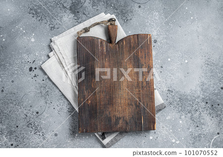 Cooking background with old empty cutting board over the towel. Gray background. Top view. Copy space Cooking background with old empty cutting board over the towel. Gray background. Top view. Copy space 101070552