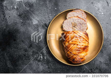Roasted bacon wrapped meatloaf, sliced mince meat loaf. Black background. Top view. Copy space Roasted bacon wrapped meatloaf, sliced mince meat loaf. Black background. Top view. Copy space 101070706