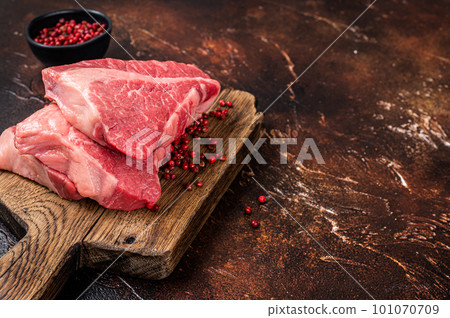 Raw sirloin beef cut, Silverside steak on a wooden board. Dark background. Top view. Copy space Raw sirloin beef cut, Silverside steak on a wooden board. Dark background. Top view. Copy space 101070709