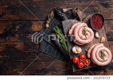Bavarian Raw spiral sausages on a wooden board. Wooden background. Top view. Copy space Bavarian Raw spiral sausages on a wooden board. Wooden background. Top view. Copy space 101070733