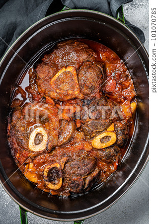 Osso buco cross cut veal shank braised with tomatoes and spices, beef meat Ossobuco. White background. Top view 101070785