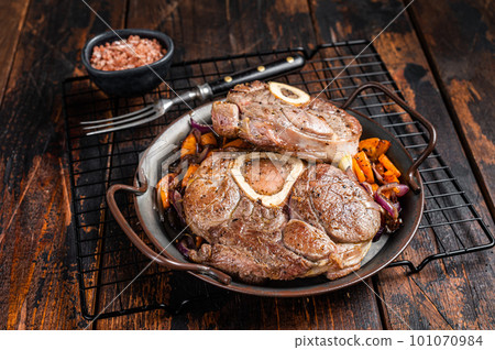 Veal shank stew Osso Buco, italian ossobuco meat steak. Wooden background. Top view 101070984