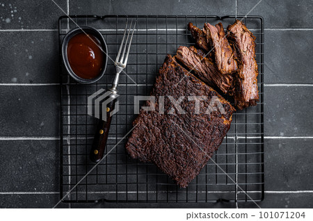 Chopped Beef Brisket barbecue, Traditional meat rubbed with spices and smoked in a Texas smoker. Black background. Top view 101071204
