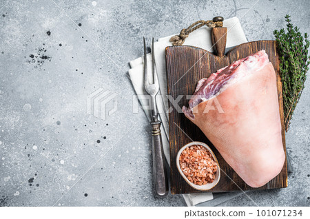 Uncooked Raw pork ham hocks, shanks on a wooden board with spices. Gray background. Top view. Copy space Uncooked Raw pork ham hocks, shanks on a wooden board with spices. Gray background. Top view. Copy space 101071234