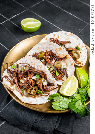 Mexican Beef Barbacoa Tacos with Cilantro and Onion. Black background. Top view 101071251
