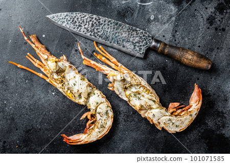 BBQ Grilled Spiny lobster sliced on a cutting board Black background. Top view 101071585