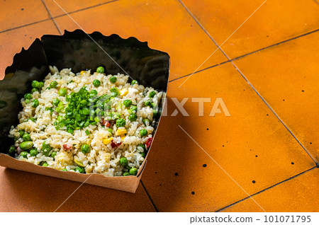 Fried rice with egg and vegetables in box take away. Orange background. Top view. Copy space Fried rice with egg and vegetables in box take away. Orange background. Top view. Copy space 101071795