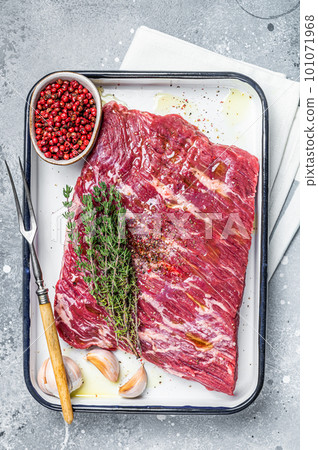 Piece of raw beef brisket with herbs and spices ready for bbq smoker. Gray background. Top view Piece of raw beef brisket with herbs and spices ready for bbq smoker. Gray background. Top view 101071968