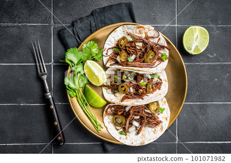Mexican Beef Barbacoa Tacos with Cilantro and Onion. Black background. Top view 101071982
