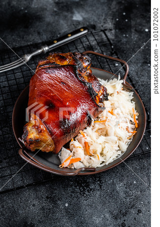 Traditional German cuisine Roasted pork knuckle Schweinshaxe with Sauerkraut. Black background. Top view 101072002