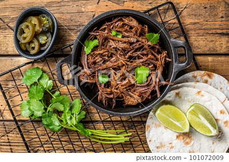 Cooking of mexican pork carnitas taco. Wooden background. Top view 101072009