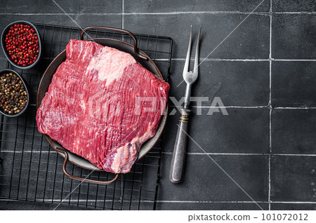Raw piece of marble beef brisket meat with spices. Black background. Top view. Copy space Raw piece of marble beef brisket meat with spices. Black background. Top view. Copy space 101072012