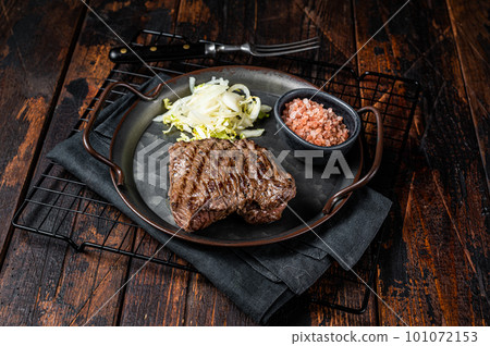 Deer venison steak with sea salt and salad. Wooden background. Top view 101072153