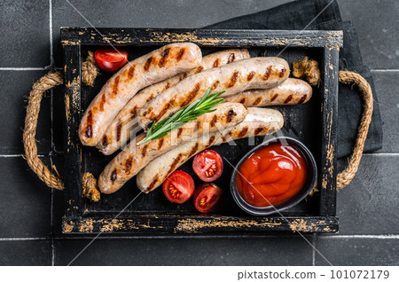 Grilled Bratwurst meat sausages with herbs and spices. Black background. Top view 101072179
