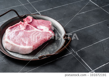 Raw pork t bone chop meat steak. Black background. Top view. Copy space Raw pork t bone chop meat steak. Black background. Top view. Copy space 101072191