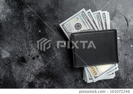 One black purse with the big pack of dollars, Cash of dollar note. Black background. Top view. Copy space One black purse with the big pack of dollars, Cash of dollar note. Black background. Top view. Copy space 101072248