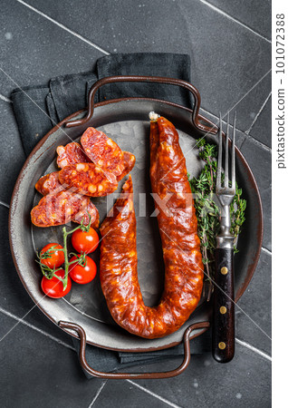 Sliced Chorizo sausage, slices of dry cured pork with herbs and spices. Black background. Top view Sliced Chorizo sausage, slices of dry cured pork with herbs and spices. Black background. Top view 101072388