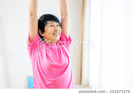 Cheerful senior woman stretching energetically 101073379