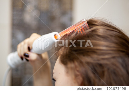 Woman uses darsonval for massage head's skin. Receiving electric darsonval facial massage procedure. Face Beauty Treatment. Darsonval Therapy Using High Frequency D'Arsonval, Skin Care Device .  Woman uses darsonval for massage head's skin. Receiving electric darsonval facial massage procedure. Face Beauty Treatment. Darsonval Therapy Using High Frequency D'Arsonval, Skin Care Device .  101073496