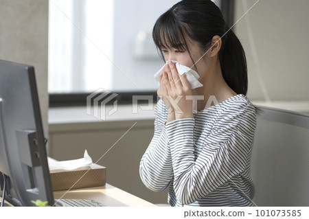 A young woman suffering from hay fever A young woman suffering from hay fever 101073585