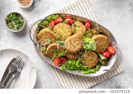 Vegan burgers in metal dish Vegan burgers in metal dish 101074128