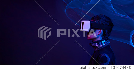 Man is using virtual reality headset to access in metaverse. 101074488