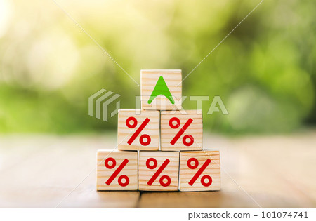 Interest rate financial and mortgage rates concept. Wooden blocks are lined up in steps with up arrow and interest symbols. Mortgage rates business concept of investment. Interest rate financial and mortgage rates concept. Wooden blocks are lined up in steps with up arrow and interest symbols. Mortgage rates business concept of investment. 101074741