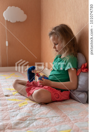 Cute girl playing alone with a doll in bedroom Cute girl playing alone with a doll in bedroom 101074780